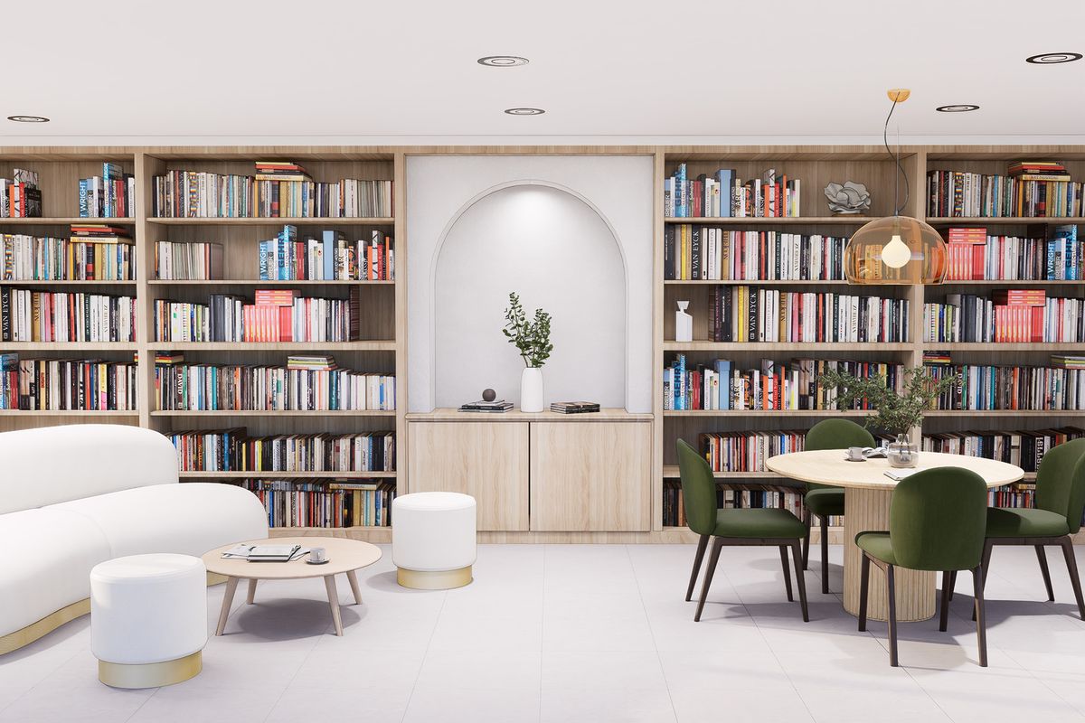 Biblioteca con libreros empotrados, nicho en arco, sofá curvo y mesa con sillas verdes
