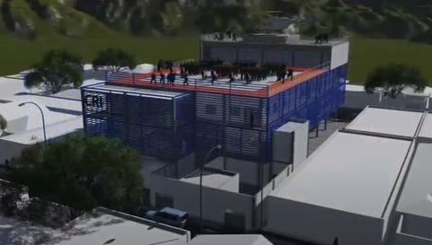 Modelo de un edificio con estructura azul en la azotea dentro de su manzana