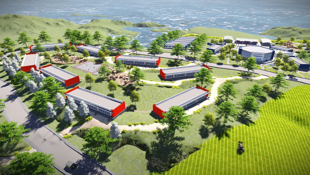 Vista aérea de un conjunto de edificios bajos con techos rojos entre senderos y árboles