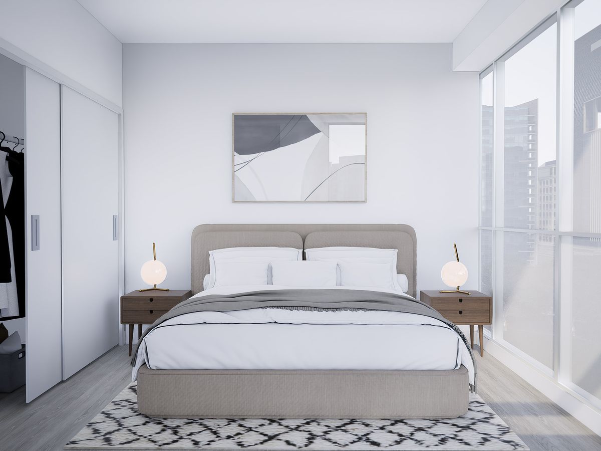 Dormitorio sereno con cama gris, mesitas de madera y puertas de armario