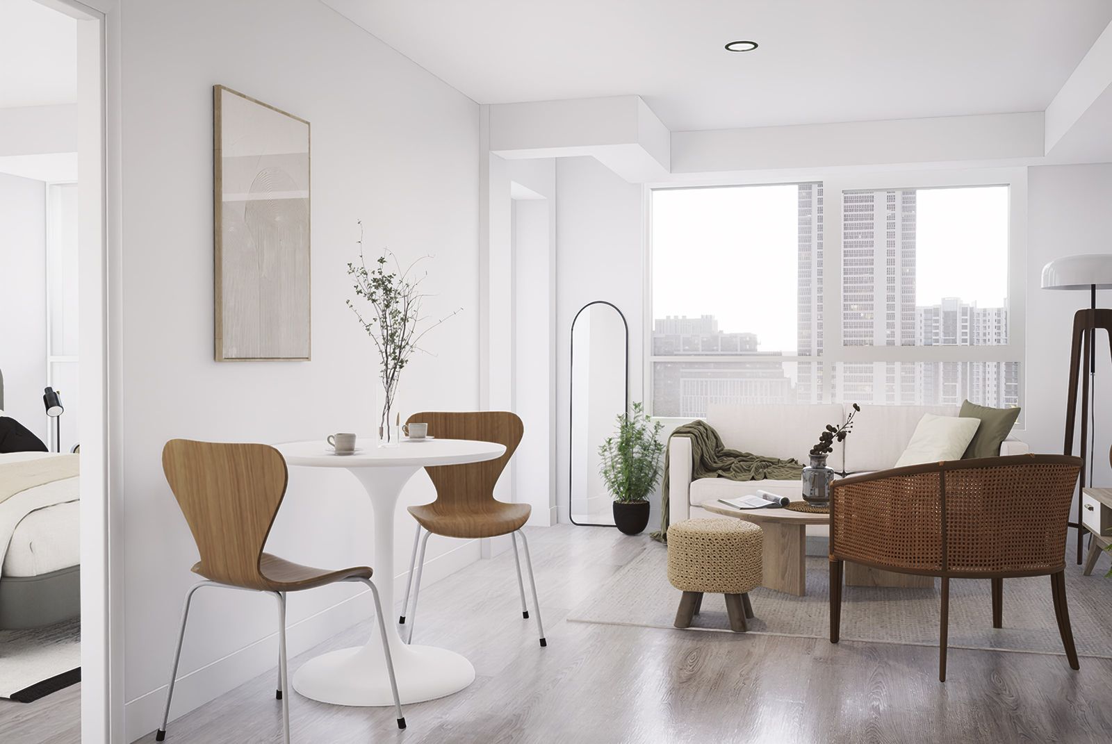 Sala-comedor con sillas de madera curvada, mesa redonda blanca y sofá